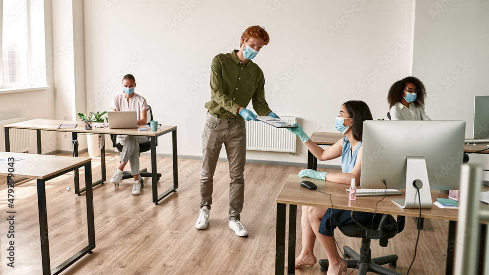 Man giving statistics report to woman during work Man giving statistics report to woman during work