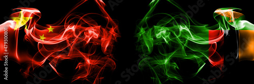 Flags of China, Chinese vs Zambia, Zambian. Smoke flag placed side by side on black background.