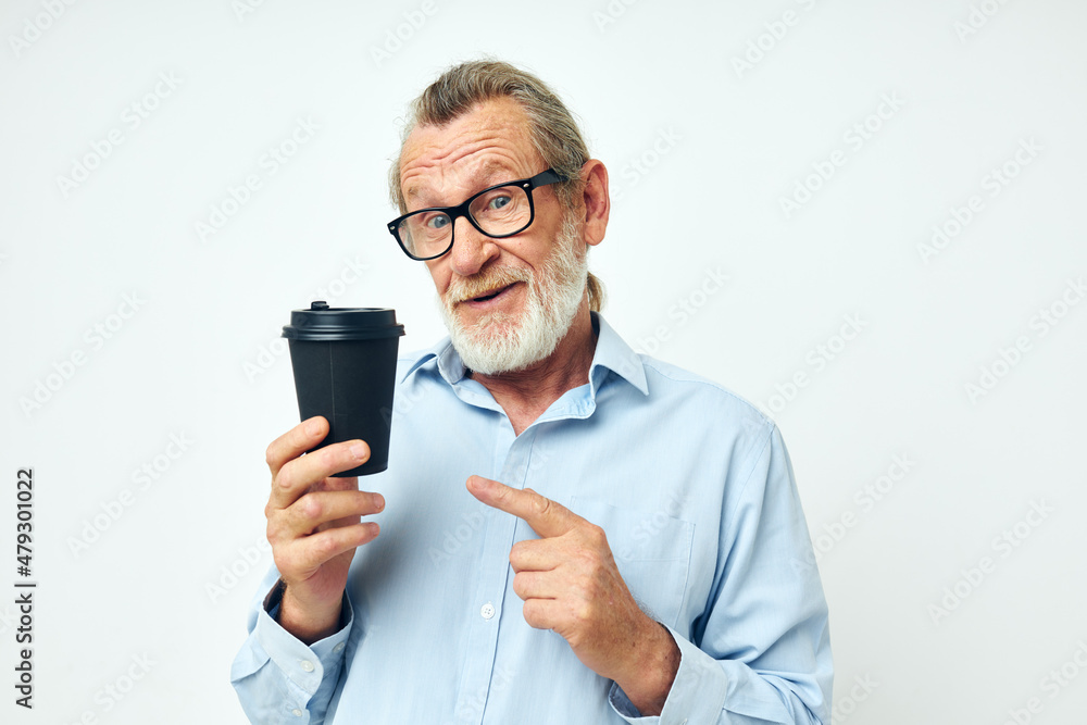 old man with a black glass in his hands a drink isolated background