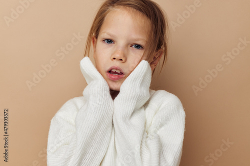 little girl in white sweater posing hand gestures childhood unaltered