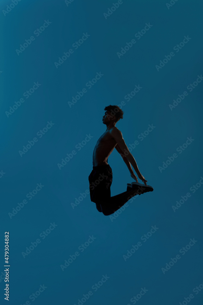 Side view of black concentrated sportsman jumping