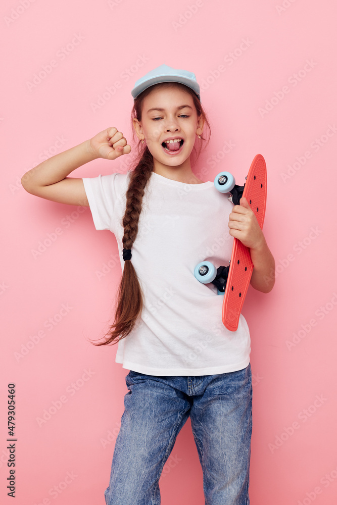 little girl cap in white t-shirt skateboard isolated background little girl cap in white t-shirt skateboard isolated background