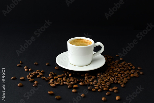 Cup of black coffee  roasted coffee beans on table on a black background  espresso  coffee couple