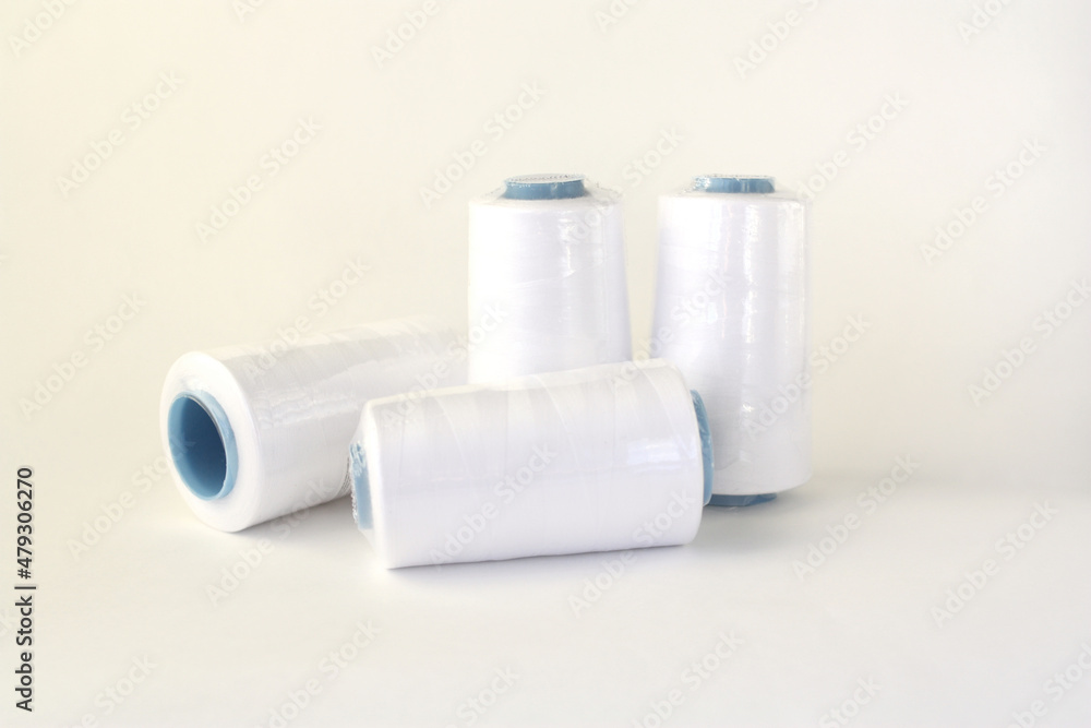Lots of spools of white thread for overlock. Lots of spools of white thread for overlock.