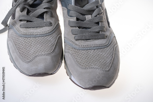 Fragment of men's fashionable suede sneakers in gray.