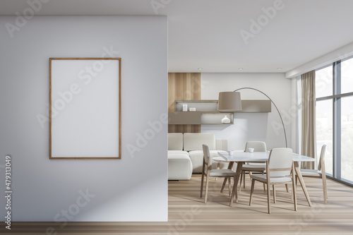 White and wood dining room with frame on wall in entrance hall