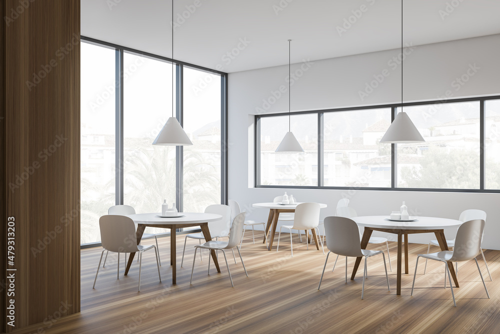 Modern cafe interior with white tables and chairs, panoramic windows Modern cafe interior with white tables and chairs, panoramic windows
