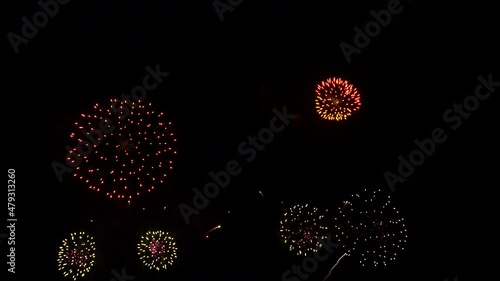 4K. loop seamless of real fireworks background. abstract blur of real golden shining fireworks with bokeh lights in the night sky. glowing fireworks show. New year's eve fireworks celebration