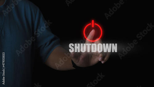 Human hand press shutdown button on virtual screen in the slide bar to unlocks. concept of system shutdown or stops working. photo