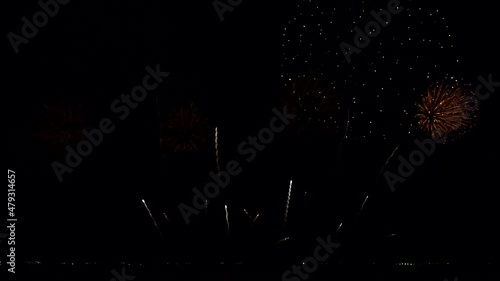 4K. loop seamless of real fireworks background. abstract blur of real golden shining fireworks with bokeh lights in the night sky. glowing fireworks show. New year's eve fireworks celebration