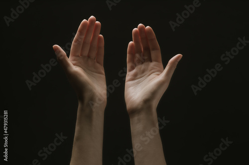 Praying hands to God in the dark. Woman hands reaching out to God or for help in barokko style © 4Max