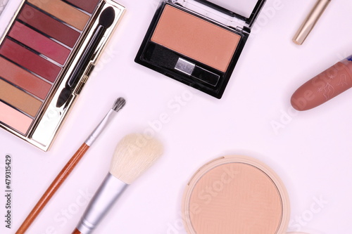 Makeup set on a white background.Eyeshadow palette , powder, blush, lipstick, pencil, brushes 