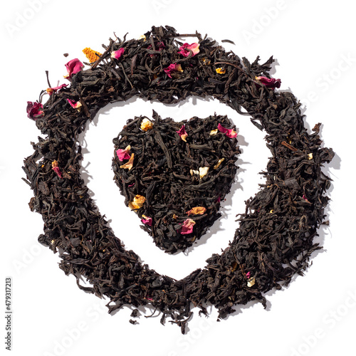 Heart shaped heap of loose-leaf black tea. Isolated on white background.