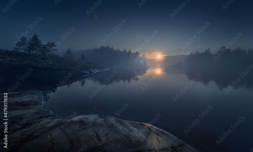 Summer Lake Ladoga. Evening Ladoga. Оpen water in the fog. Mystical landscape. Northern nature. Reflection in the water in the fog. Ladoga skerries. Republic of Karelia. Foggy landscape. 