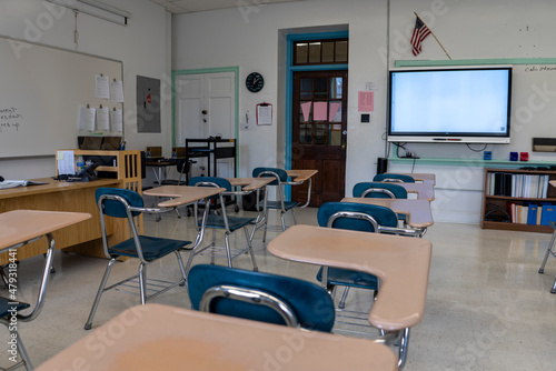 Empty schoolroom with interactive whiteboard for teaching students in high, middle, and elementary school.