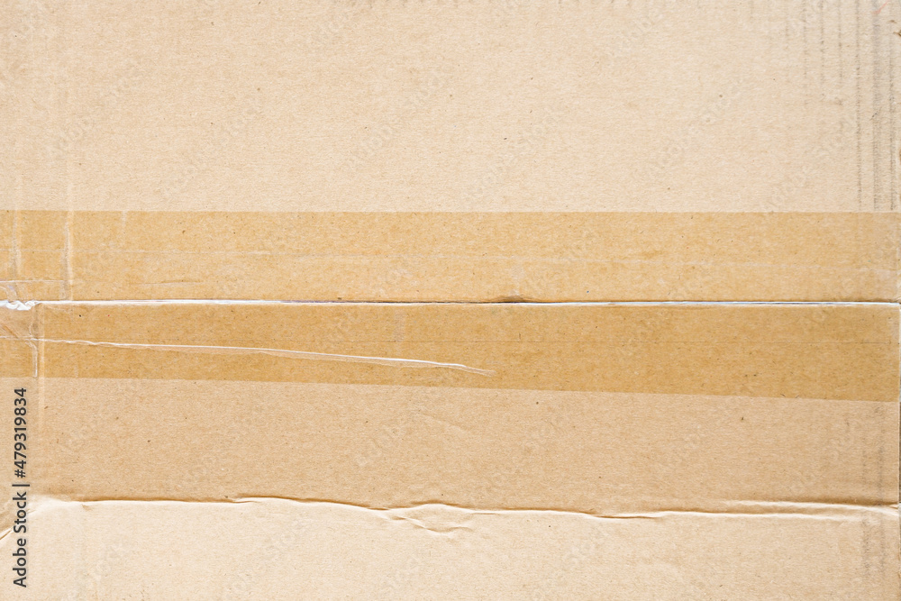 Brown paper box or Corrugated cardboard sheet with tape background Brown paper box or Corrugated cardboard sheet with tape background