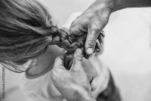 braiding a braid in a girl