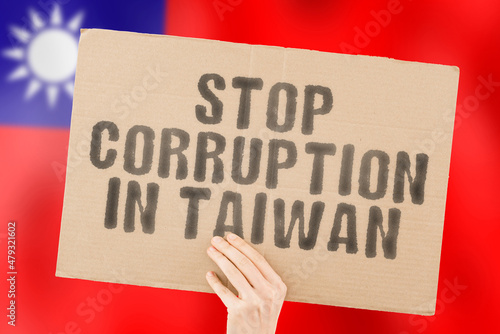 The phrase " Stop Corruption in Taiwan " on a banner in men's hand with blurred Taiwanese flag on the background. Forbidden. Prevent. Wealth. Offence. Corruptness. Economy. Corruptible