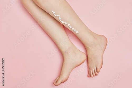 Skin moistening cream applied to a woman s leg after hair removal  concept of skin care