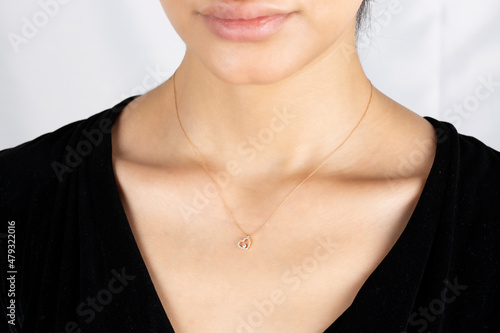 Diamond and gold. Close-up detail of young lady's diamond and gold necklace