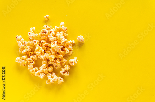 Popcorn on yellow background with copy space