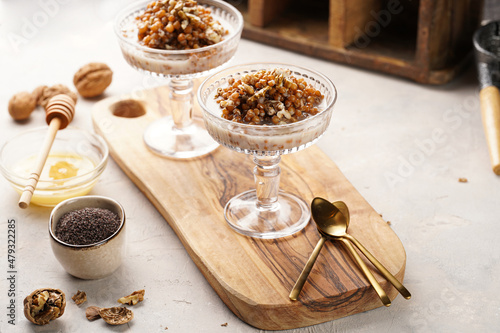 Traditional east european (ukrainian, polish, belarusian) religious christmas dish kutia made of wheat, poppy seeds, honey, walnuts and dried berries. modern style in champagne glasses