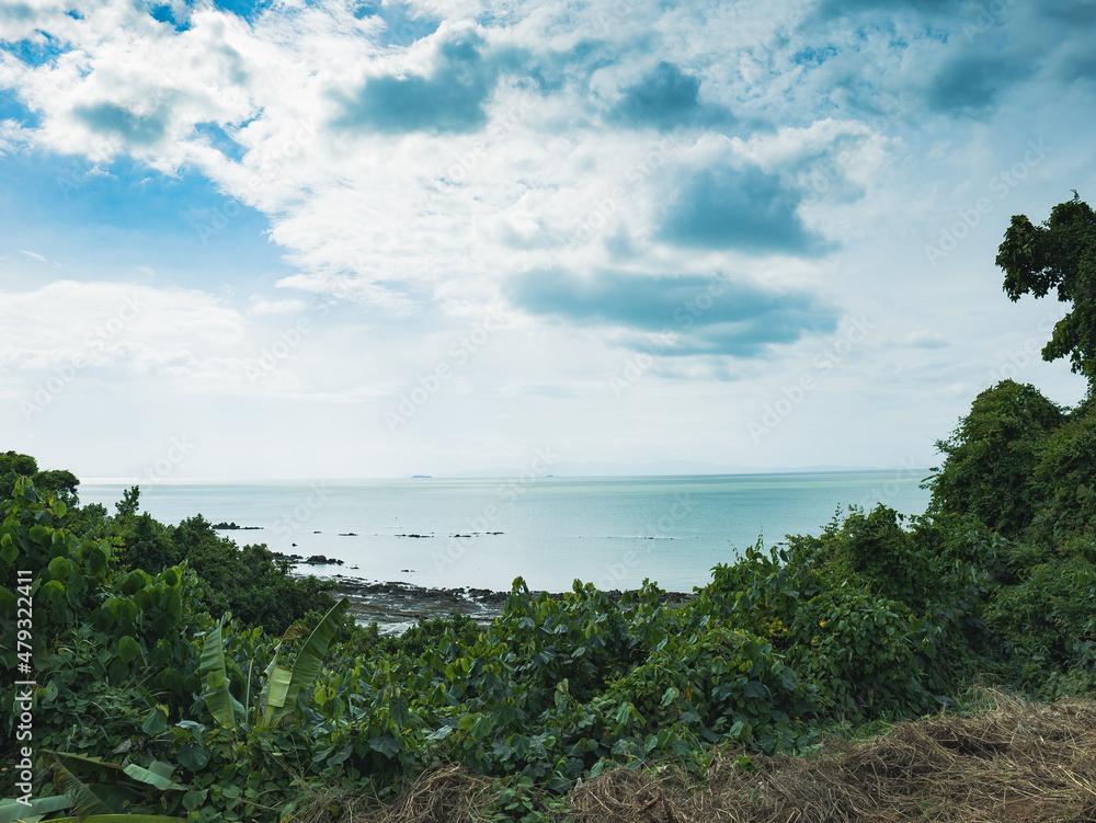A panoramic view of the sea, trees and sky in southern Thailand.