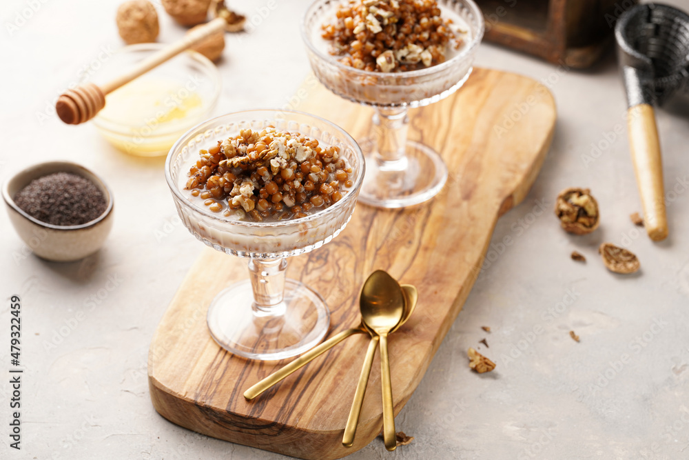 Fototapeta premium Traditional east european (ukrainian, polish, belarusian) religious christmas dish kutia made of wheat, poppy seeds, honey, walnuts and dried berries. modern style in champagne glasses