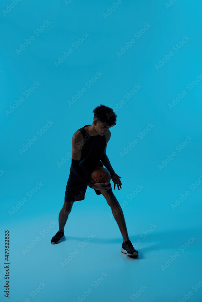 Black focused player dribble with basketball ball