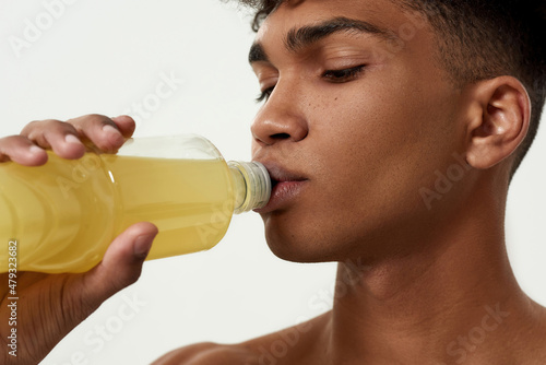 Close up of black sportsman drinking sport drink