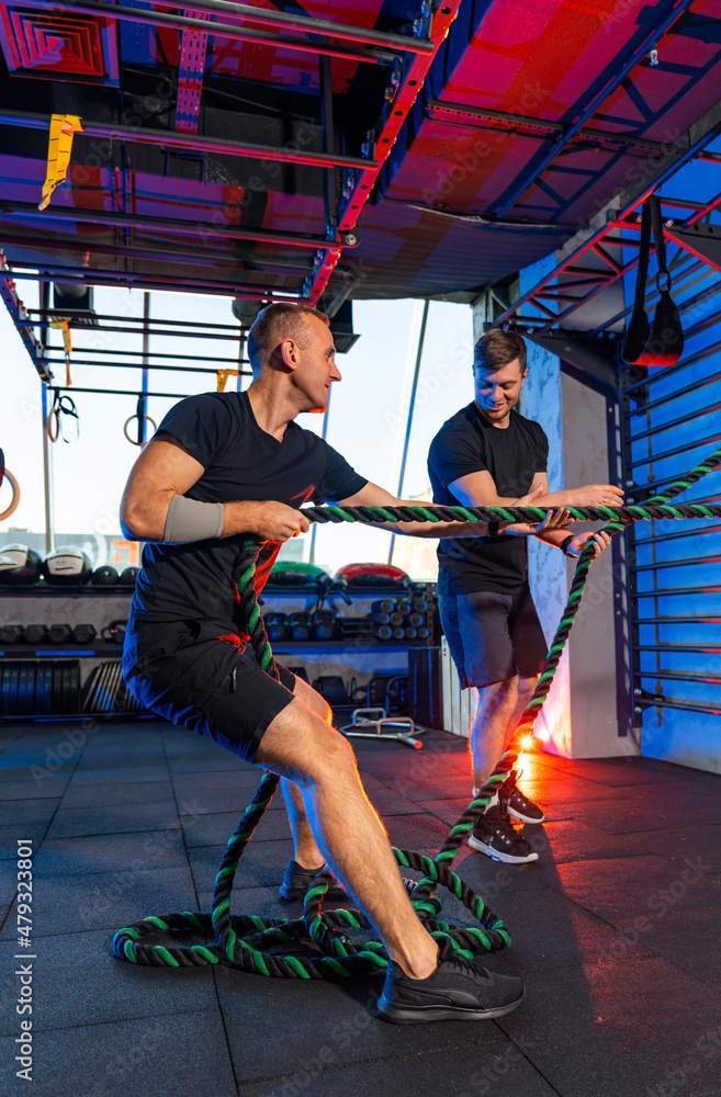 Active lifestyle peolpe doing hard exercise. Muscular strong men training in the gym. Active lifestyle peolpe doing hard exercise. Muscular strong men training in the gym.