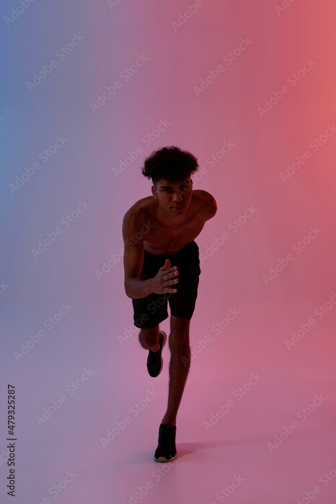 Serious sportsman running and looking at camera Serious sportsman running and looking at camera