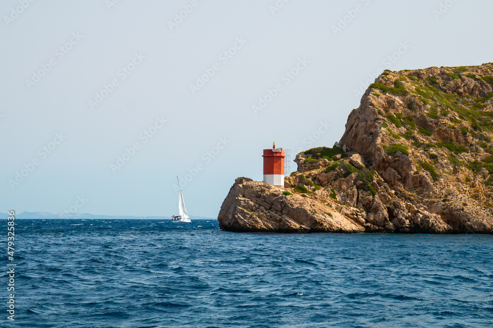 Sailing yacht at cape of Cabrera Island, Spain