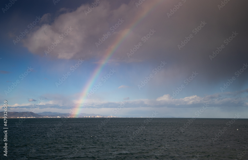 rainbow over the sea sky clearing after storm