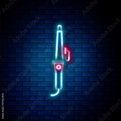 Glowing neon line Curling iron for hair icon isolated on brick wall background. Hair straightener icon. Colorful outline concept. Vector