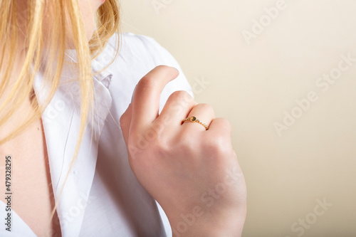 Close portrait of female model in gold and silver rings. Isolated on white background . Diamond jewelry. Diamond ring in women's hands