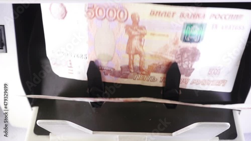 Electronic money counter machine is counting the Russian five-thousandth ruble banknotes photo