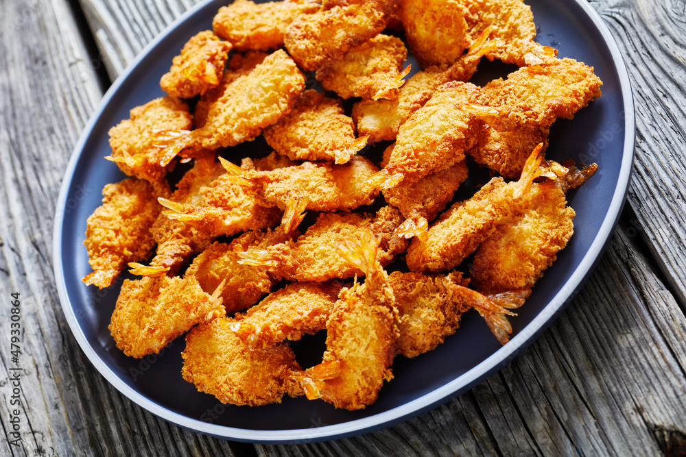 Crispy Fried Butterfly Shrimp on a grey plate Crispy Fried Butterfly Shrimp on a grey plate