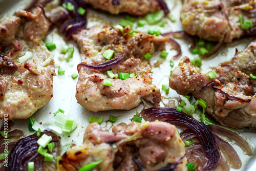 Sheet Pan chicken with onions close-up. Baked chicken fillet with onions