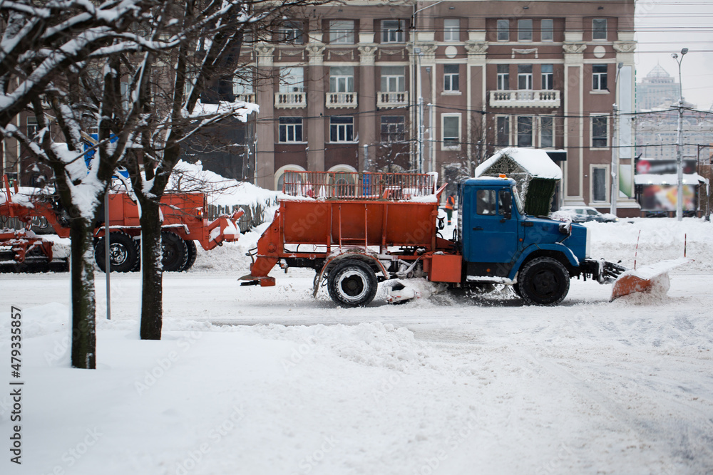 Obraz premium Snowplow removing snow from city road