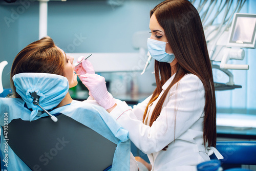 Fotografie Young woman  at the dentist's chair during a dental procedure