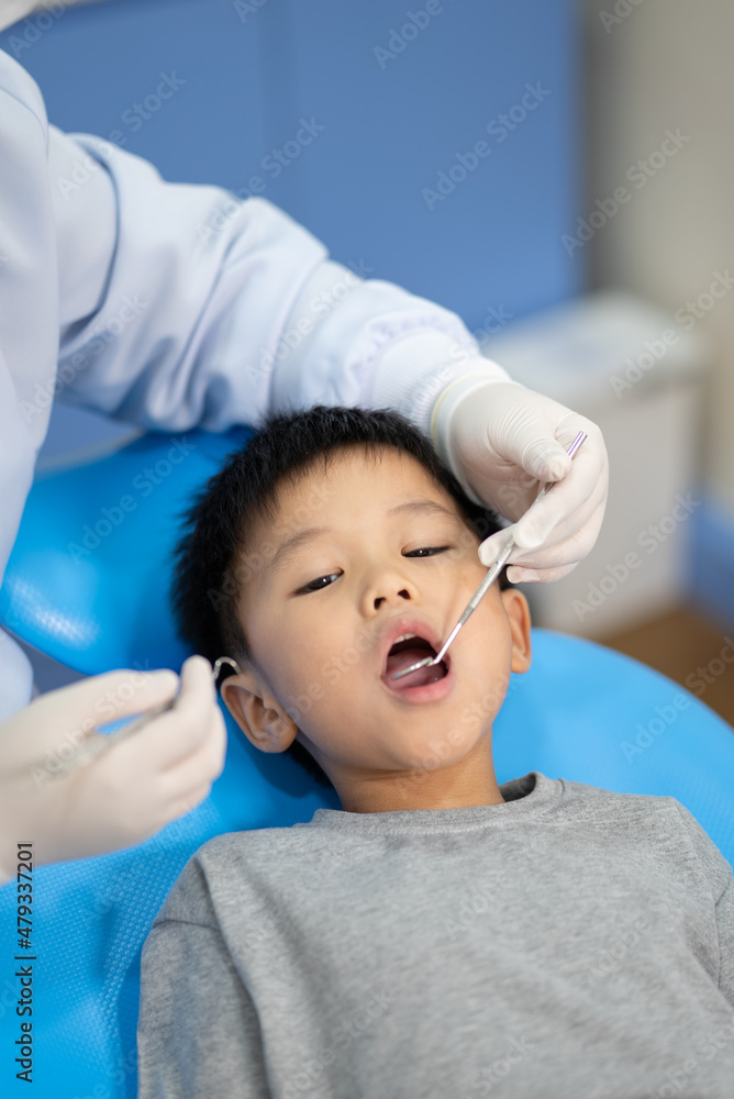 Asian kid check up with dentist at the dental clinic. Concept of dental check up and healthcare