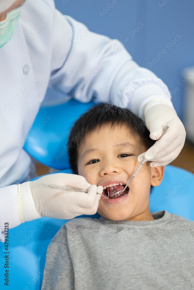 Asian kid check up with dentist at the dental clinic. Concept of dental check up and healthcare Asian kid check up with dentist at the dental clinic. Concept of dental check up and healthcare