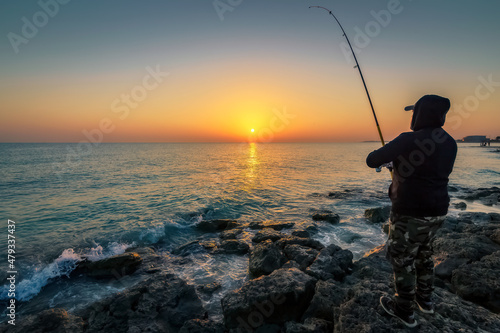 An young man fishing at RAS TANURA Beach near Jubail, Saudi Arabia.