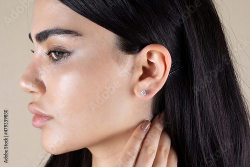 Jewelry, earrings in a beautiful girl's ear, women's accessories, gold earrings, earrings with stones, special diamonds