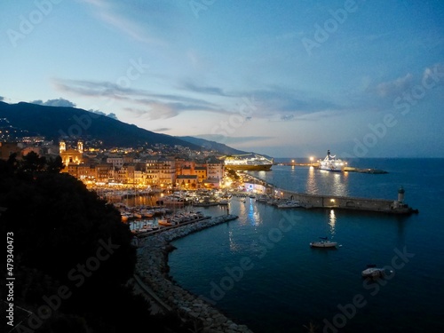  Old town and harbor of Bastia seen from the citadel at night. Corsica, France.