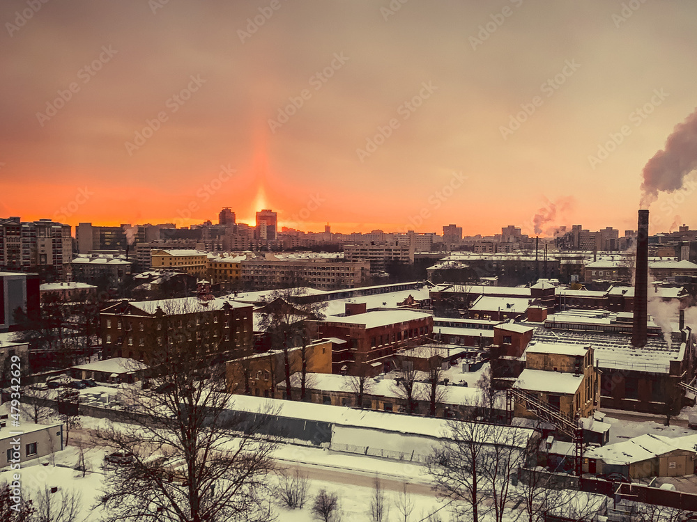 View from a frosty window on a snow-covered city in winter