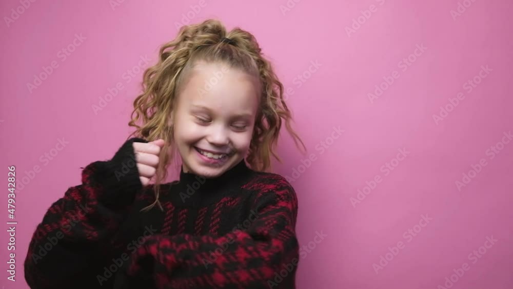 Dancing happy little girl on pink background. Smiling child having fun performing freestyle dance. Dancing happy little girl on pink background. Smiling child having fun performing freestyle dance.