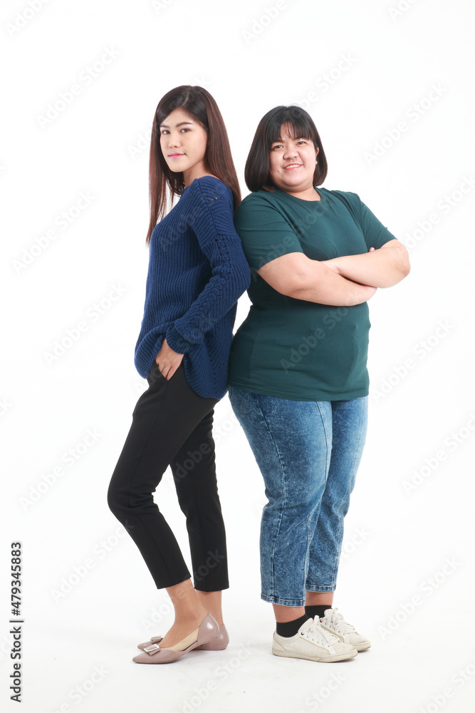 Portrait. Two fat and skinny Asian women. standing on a white background Happy smile. The concept of health care to lose weight. Portrait. Two fat and skinny Asian women. standing on a white background Happy smile. The concept of health care to lose weight.