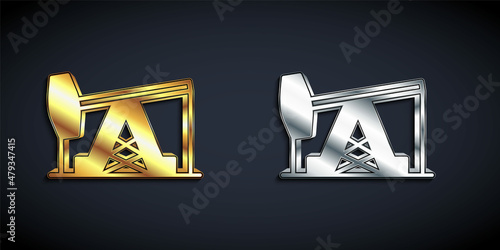 Gold and silver Oil pump or pump jack icon isolated on black background. Oil rig. Long shadow style. Vector